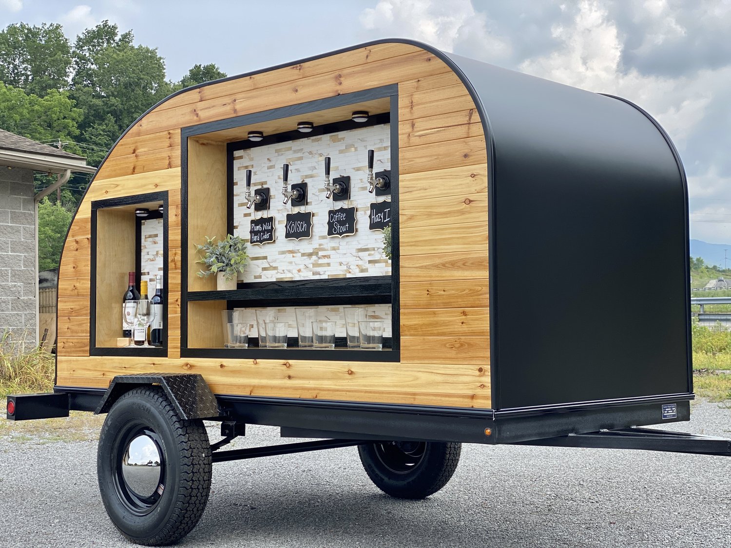 The Nomad Taverns mobile tap trailer set up and pouring at an event